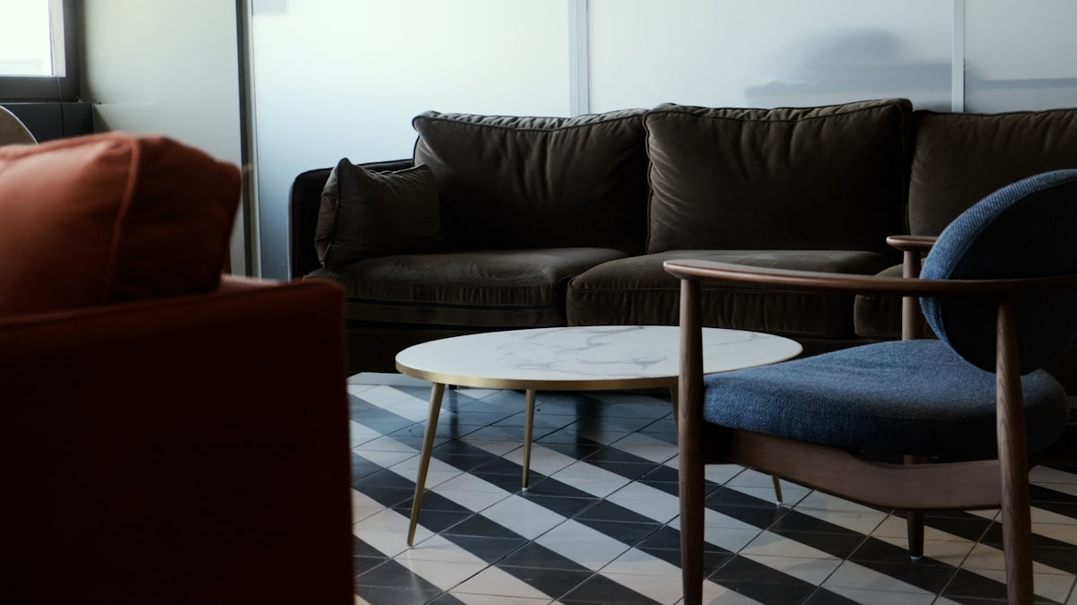 a living room filled with furniture and a checkered floor