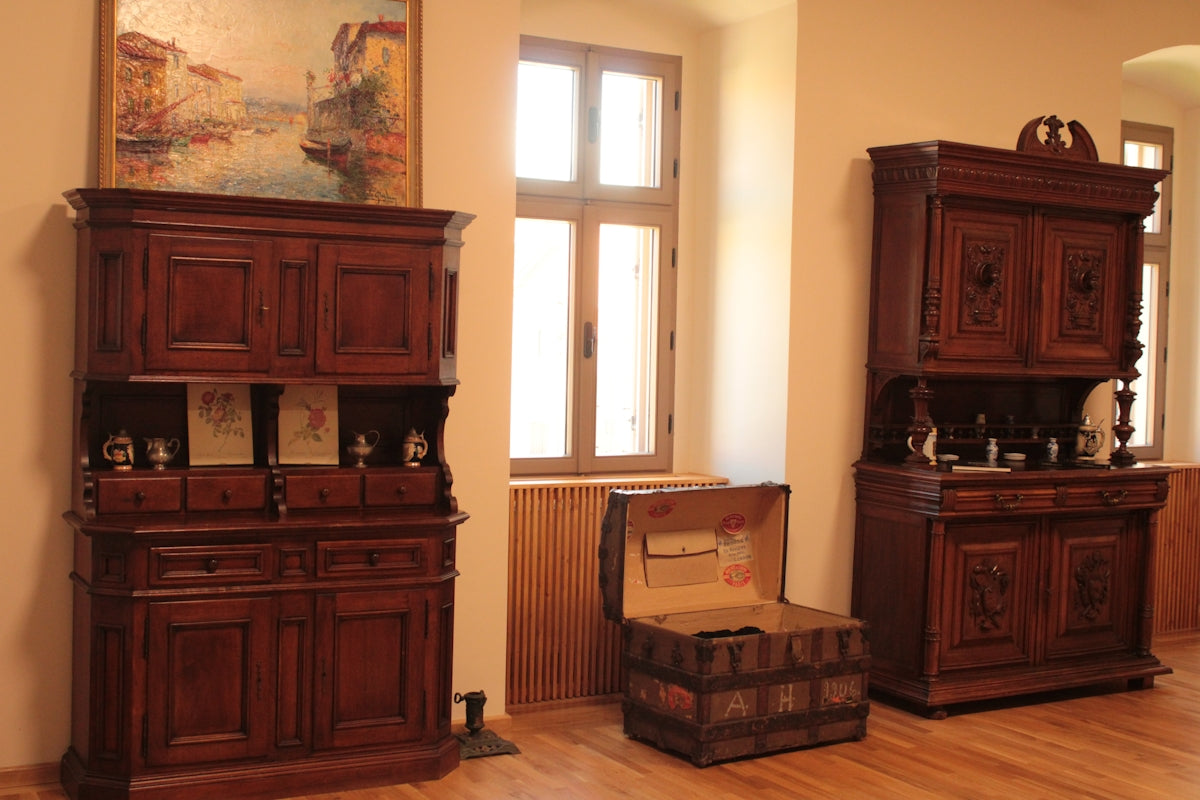 a room with wooden furniture and a painting on the wall