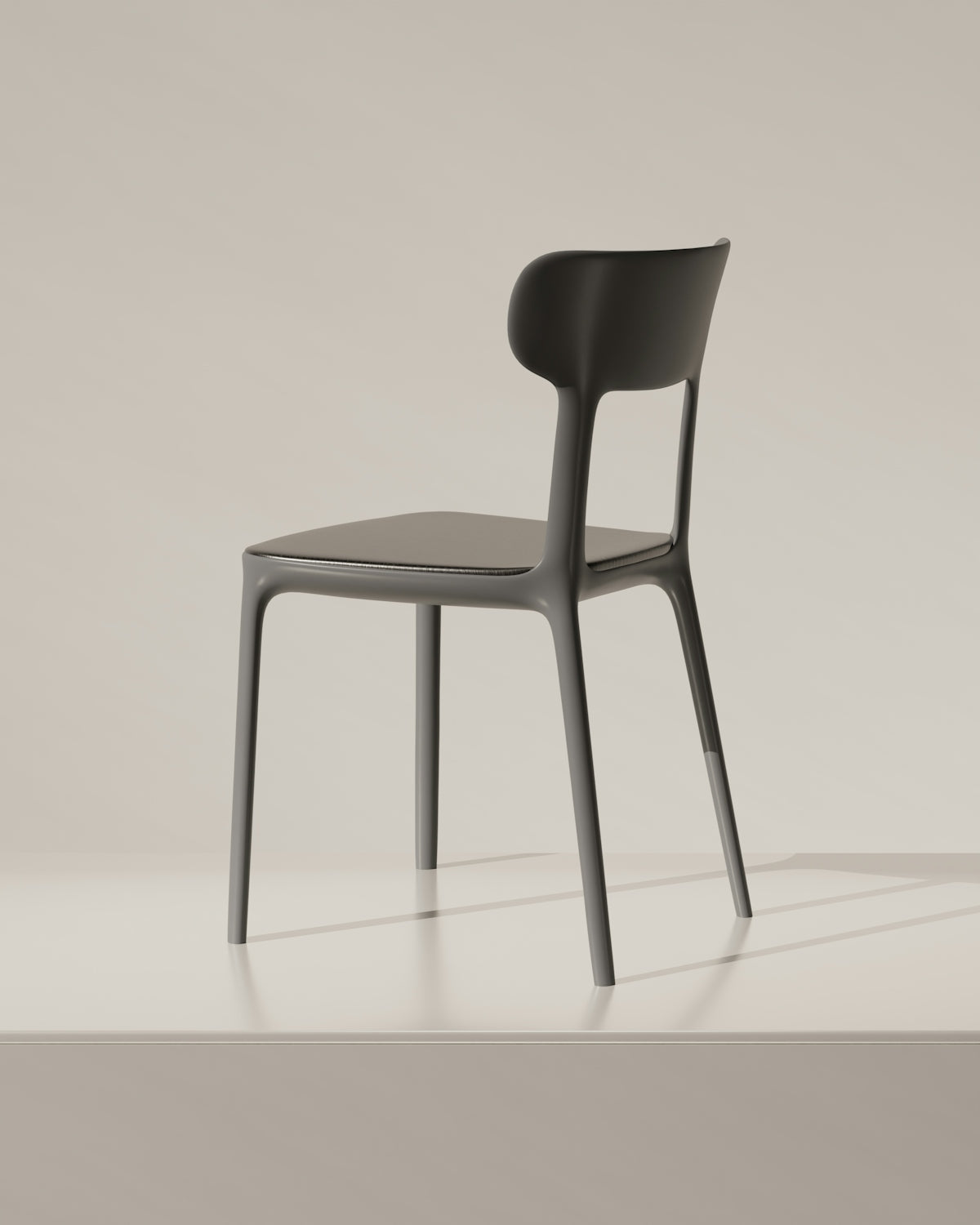 A sleek, modern chair in a studio.