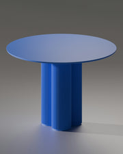 A modern blue table with a unique base.